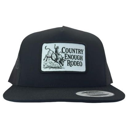 Yupoong 6006 flat bill snapback with a patch that contains graphic of a bullrider and bucking bull and words country enough rodeo #black