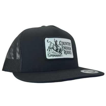 Yupoong 6006 flat bill snapback with a patch that contains graphic of a bullrider and bucking bull and words country enough rodeo #black