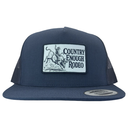 Yupoong 6006 flat bill snapback with a patch that contains graphic of a bullrider and bucking bull and words country enough rodeo #navy