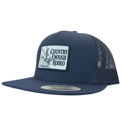 Yupoong 6006 flat bill snapback with a patch that contains graphic of a bullrider and bucking bull and words country enough rodeo #navy