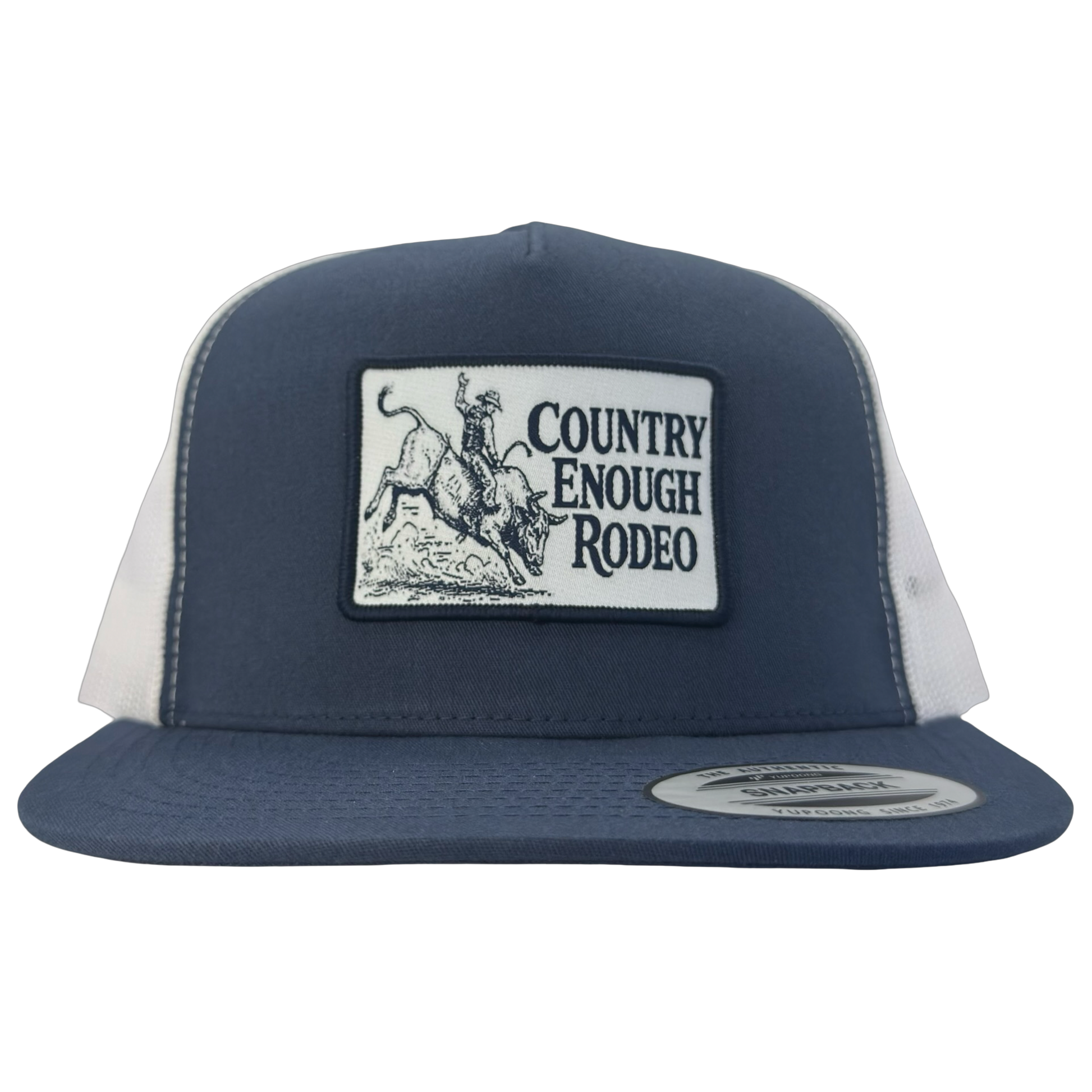 Yupoong 6006 flat bill snapback with a patch that contains graphic of a bullrider and bucking bull and words country enough rodeo #navy/white