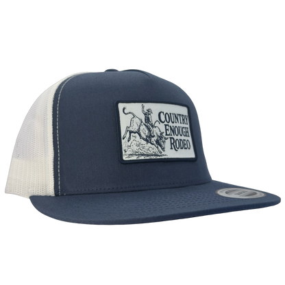 Yupoong 6006 flat bill snapback with a patch that contains graphic of a bullrider and bucking bull and words country enough rodeo #navy/white