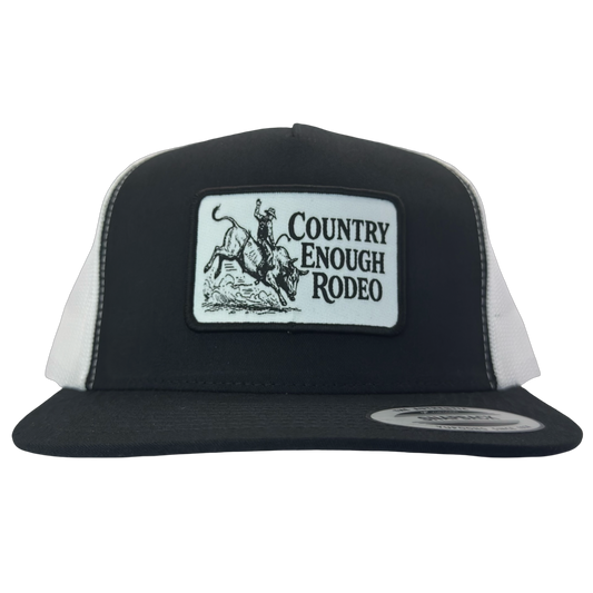 Yupoong 6006 flat bill snapback with a patch that contains graphic of a bullrider and bucking bull and words country enough rodeo #black/white