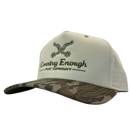 Legacy heritage snapback hat with graphic of spurs and words country enough hat company #bottomland