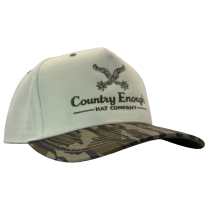 Legacy heritage snapback hat with graphic of spurs and words country enough hat company #bottomland