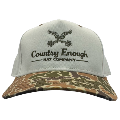 Legacy heritage snapback hat with graphic of spurs and words country enough hat company #duckcamo