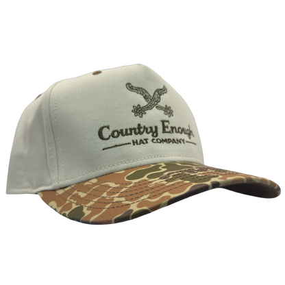 Legacy heritage snapback hat with graphic of spurs and words country enough hat company #duckcamo