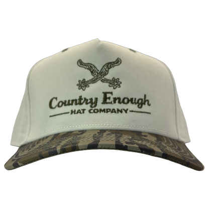 Legacy heritage snapback hat with graphic of spurs and words country enough hat company #bottomland