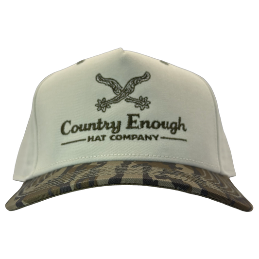 Legacy heritage snapback hat with graphic of spurs and words country enough hat company #bottomland