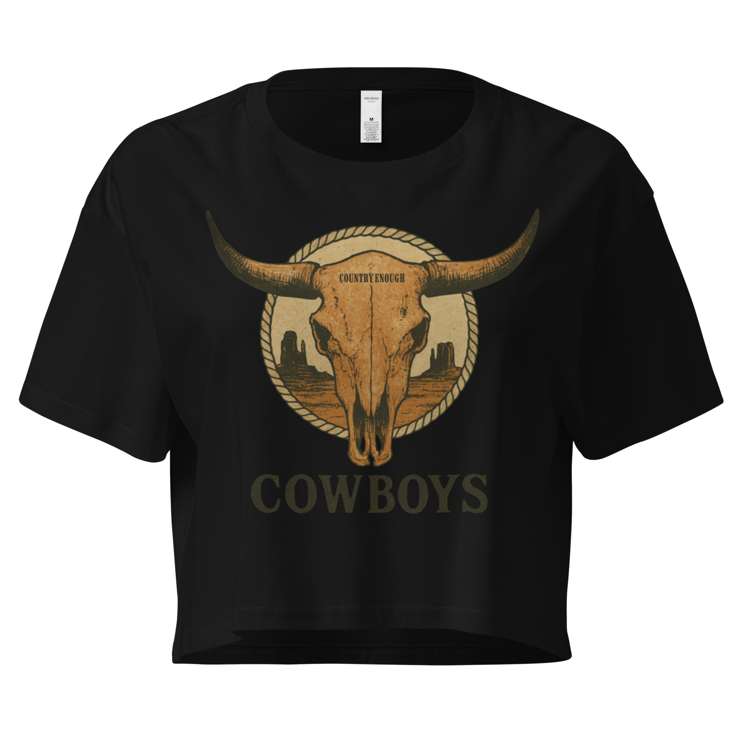 Black crop top with graphic of bull skull in front of a circular desert landscape with rope border and word cowboy below #black