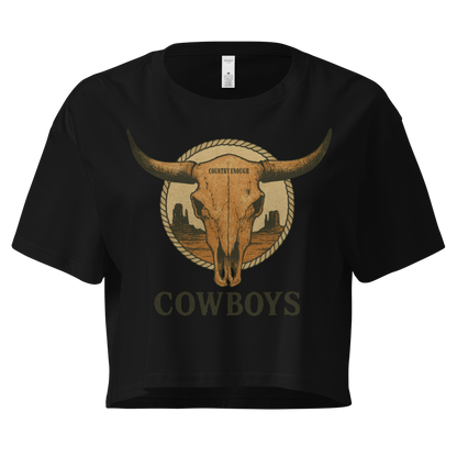 Black crop top with graphic of bull skull in front of a circular desert landscape with rope border and word cowboy below #black