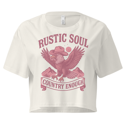 Ecru crop top with graphic of cowboy hat wearing eagle, mountains, and words rustic soul and country enough #ecru