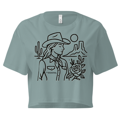 Mineral crop top with graphic of a cowgirl, desert landscape, sun, cacti, and rose #mineral
