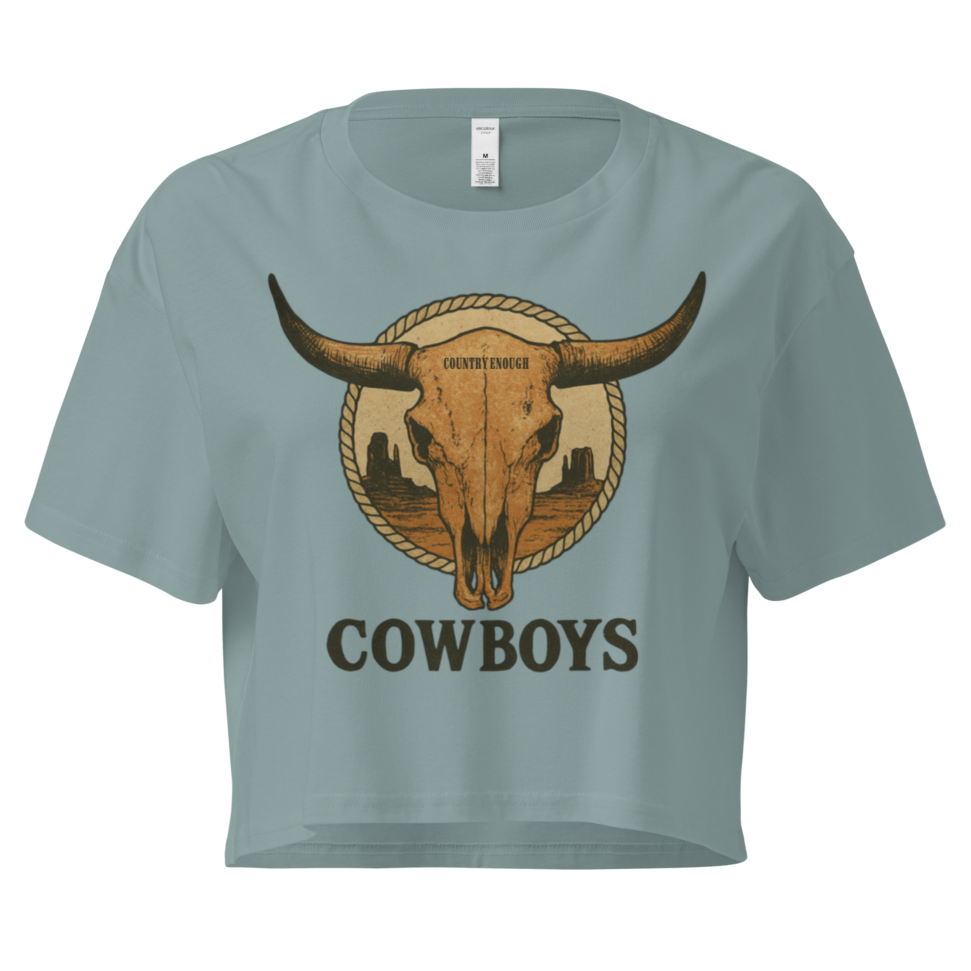 Mineral crop top with graphic of bull skull in front of a circular desert landscape with rope border and word cowboy below #mineral