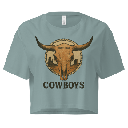 Mineral crop top with graphic of bull skull in front of a circular desert landscape with rope border and word cowboy below #mineral