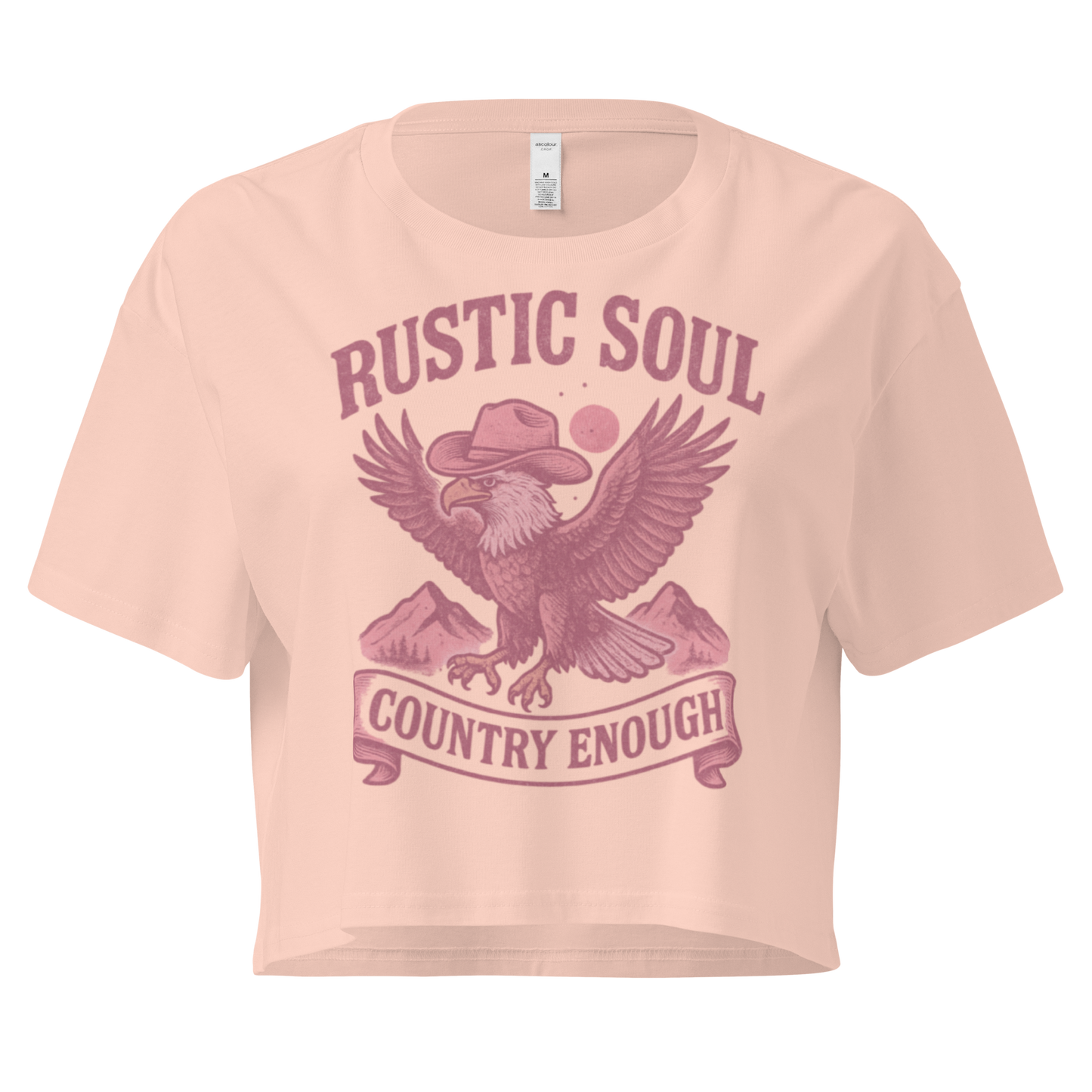 Pale Pink crop top with graphic of cowboy hat wearing eagle, mountains, and words rustic soul and country enough #palepink