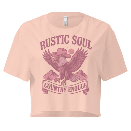 Pale Pink crop top with graphic of cowboy hat wearing eagle, mountains, and words rustic soul and country enough #palepink