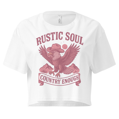 White crop top with graphic of cowboy hat wearing eagle, mountains, and words rustic soul and country enough #white