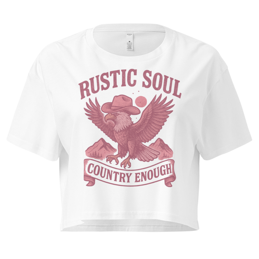 White crop top with graphic of cowboy hat wearing eagle, mountains, and words rustic soul and country enough #white