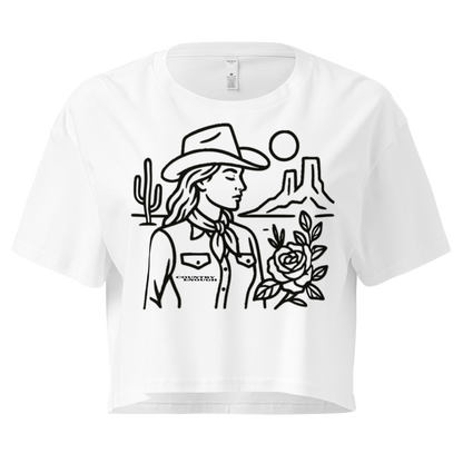 White crop top with graphic of a cowgirl, desert landscape, sun, cacti, and rose #white
