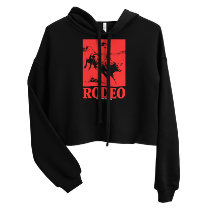 Black crop hoodie with bright red graphic of a cowgirl riding a bull with word rodeo in big letters below #black