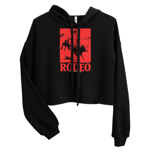 Black crop hoodie with bright red graphic of a cowgirl riding a bull with word rodeo in big letters below #black