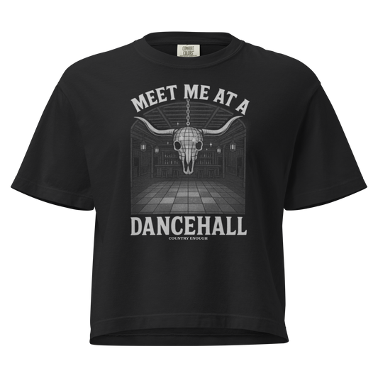 Black t-shirt with graphic of a bar scene, bull skull shaped disco ball, and the words meet me at a dancehall #black