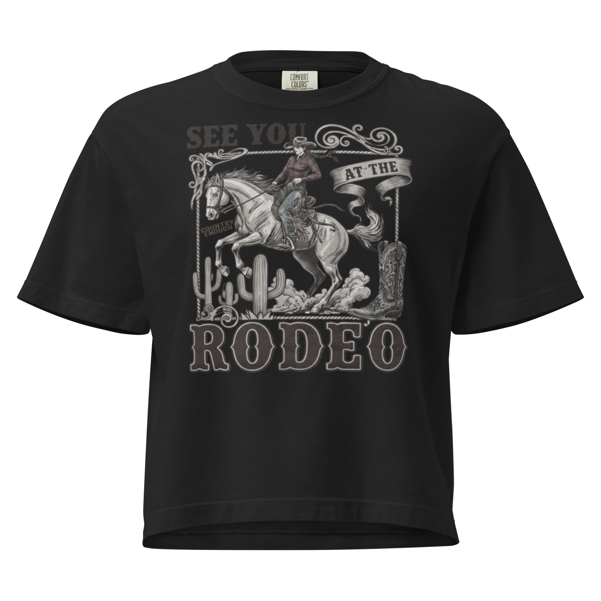Black t-shirt with graphic of cowgirl, cowboy boot, cacti, horse, and words see you at the rodeo #black