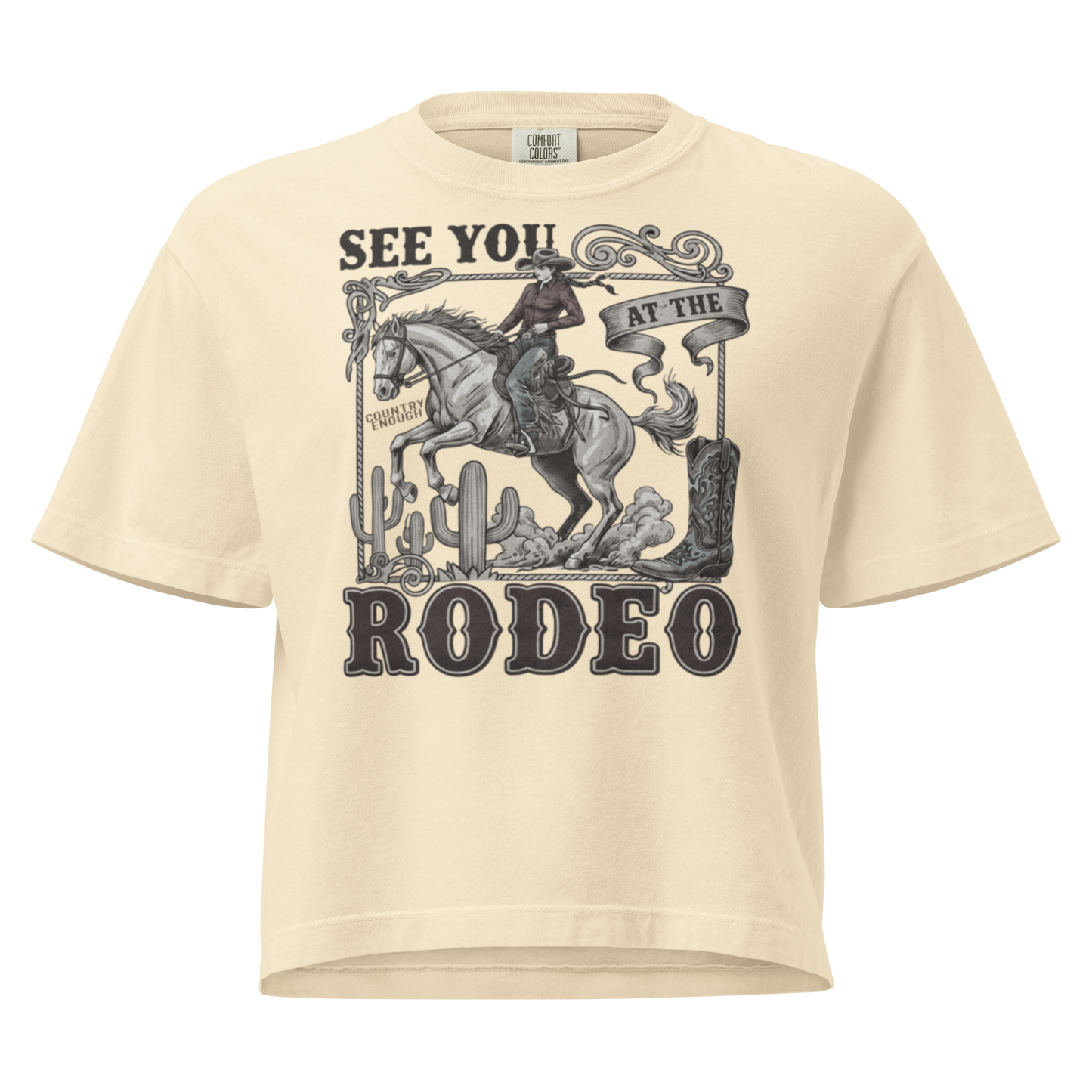 Ivory t-shirt with graphic of cowgirl, cowboy boot, cacti, horse, and words see you at the rodeo #ivory
