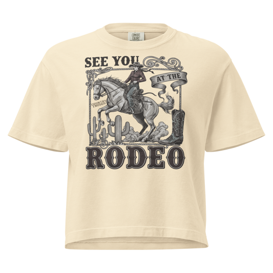 Ivory t-shirt with graphic of cowgirl, cowboy boot, cacti, horse, and words see you at the rodeo #ivory