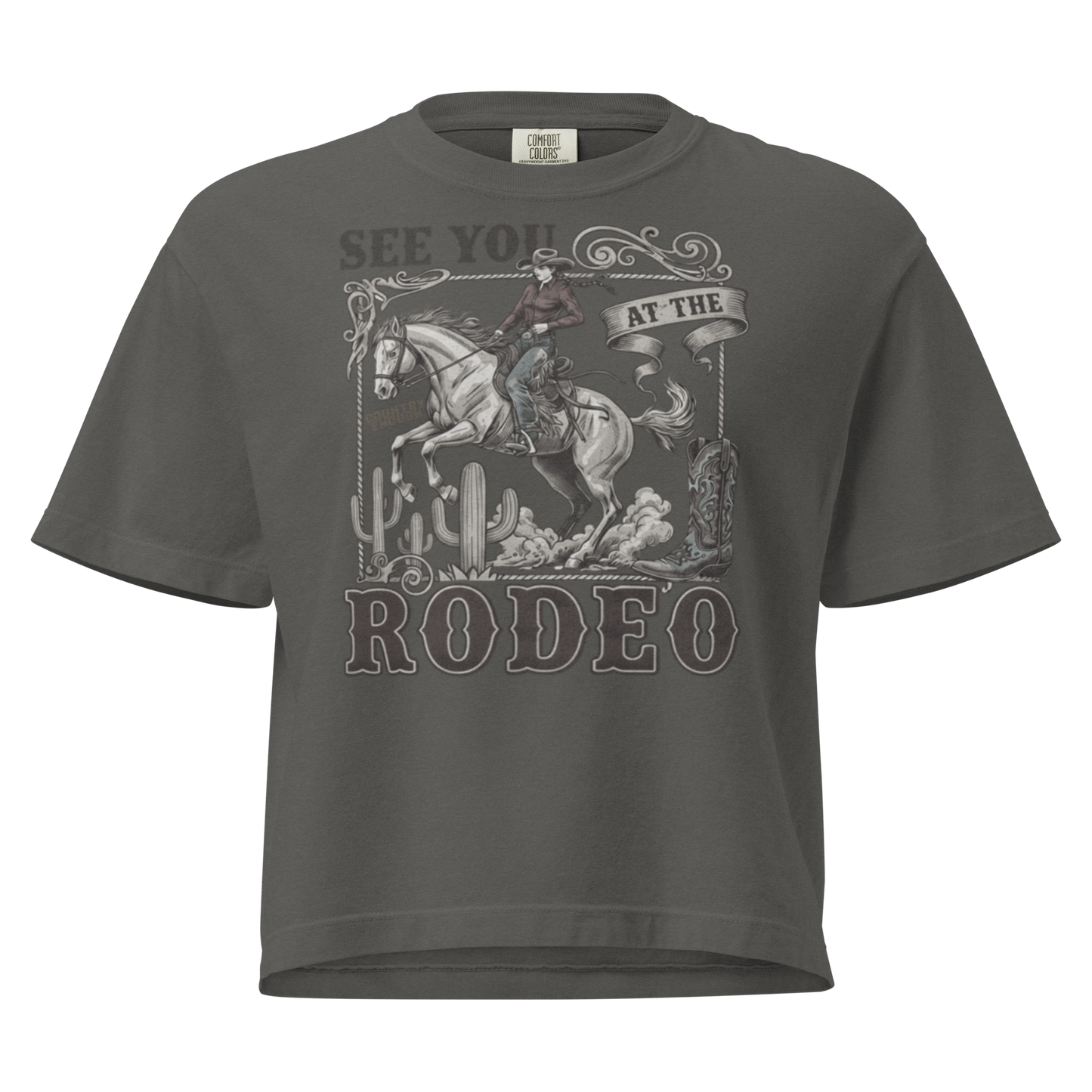 Gray t-shirt with graphic of cowgirl, cowboy boot, cacti, horse, and words see you at the rodeo #gray