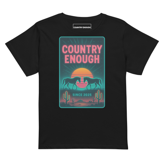 Black t-shirt with graphic of horses, cacti, desert landscape, and sunshine with words country enough #black