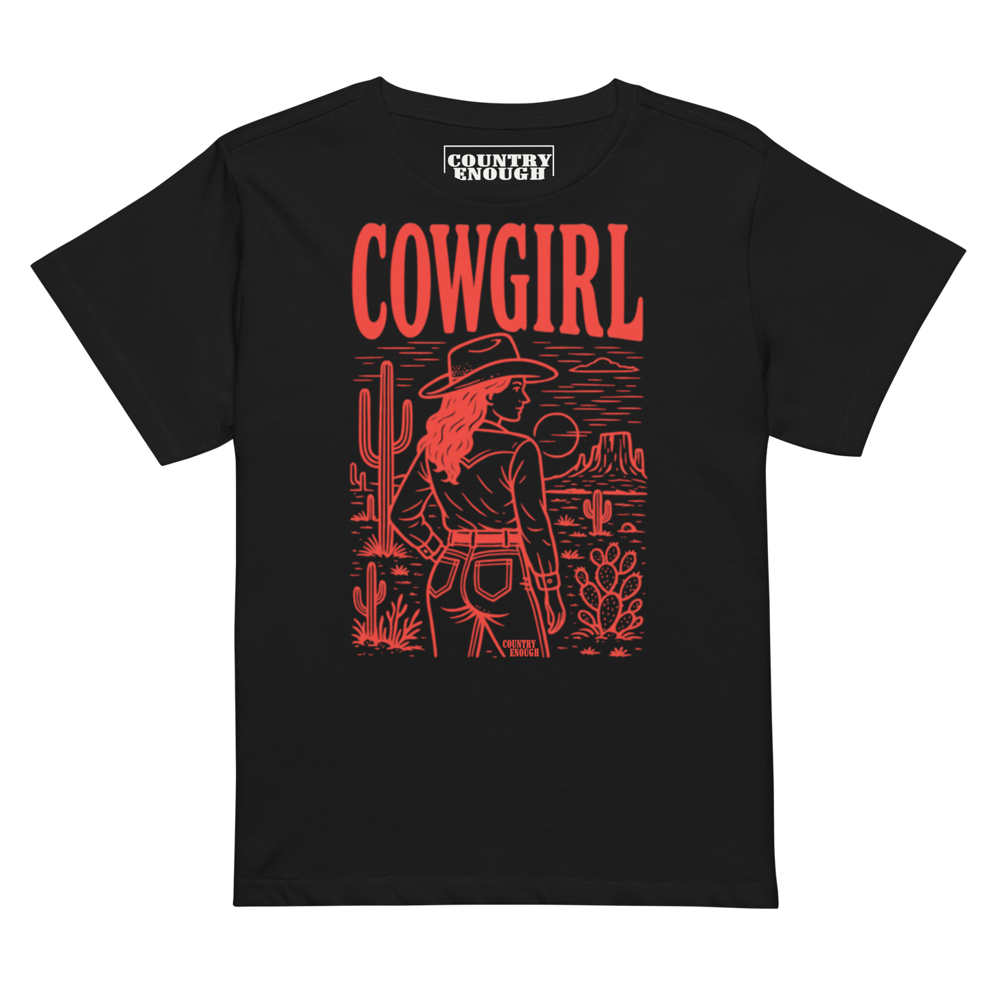 Black t-shirt of cowgirl standing in a desert scene with words cowgirl. all in bright red coloring #black