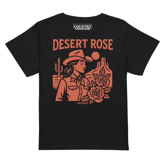 Black t-shirt with graphic of cowgirl, desert landscape, roses, and words desert rose #black