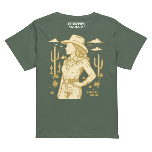 Pine t-shirt with graphic of a cowgirl, clouds, one mountain, and cacti #pine