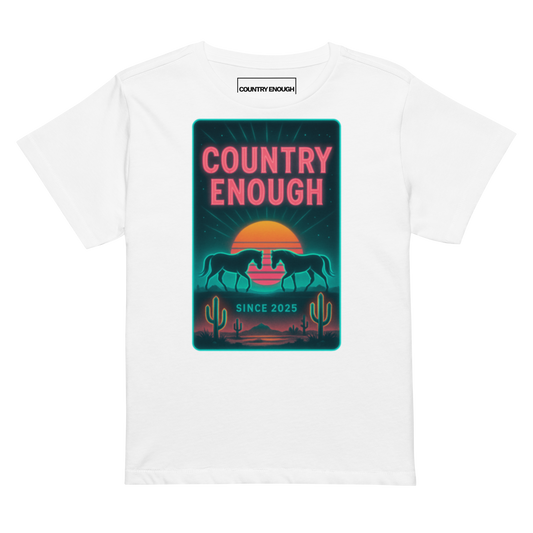 White t-shirt with graphic of horses, cacti, desert landscape, and sunshine with words country enough #white