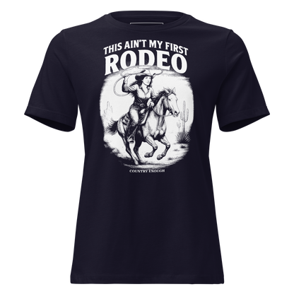 Navy t-shirt with graphic of cowgirl and horse lassoing in a desert scene with the words this ain't my first rodeo and country enough #navy