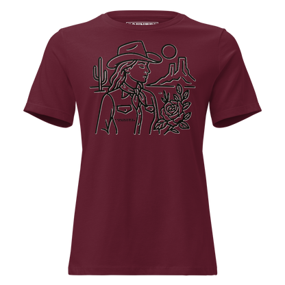 Women's t-shirt with graphic of a cowgirl, desert landscape, sun, cacti, and rose #maroon