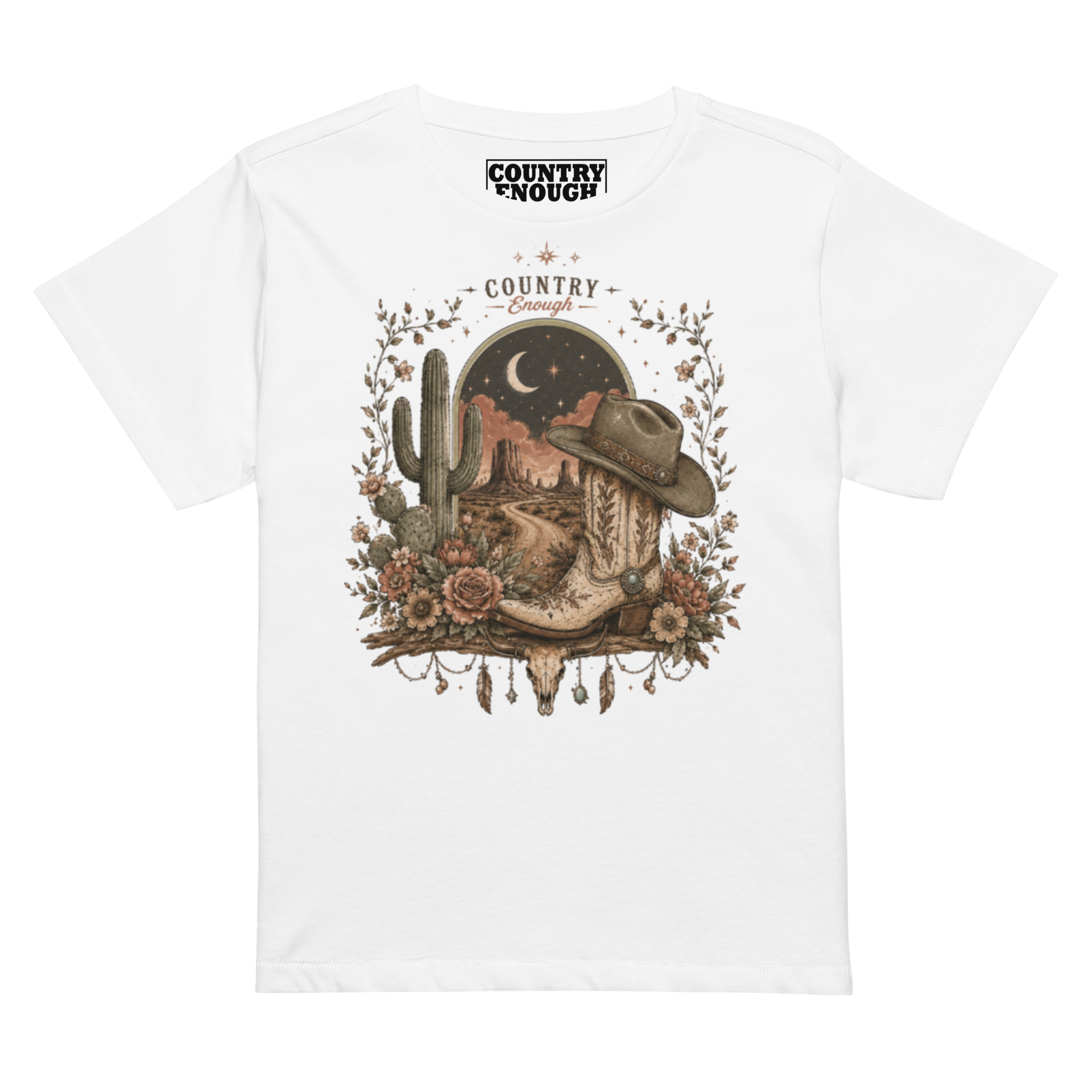Women's t-shirt with graphic of bull skull, cowboy boot, cowboy hat, desert landscape and night sky. #white