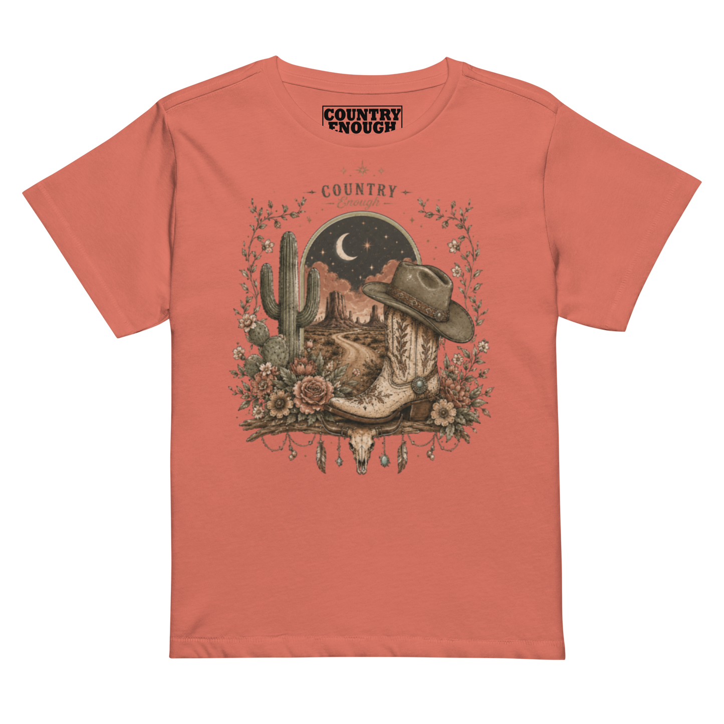 Women's t-shirt with graphic of bull skull, cowboy boot, cowboy hat, desert landscape and night sky. #redsorbet