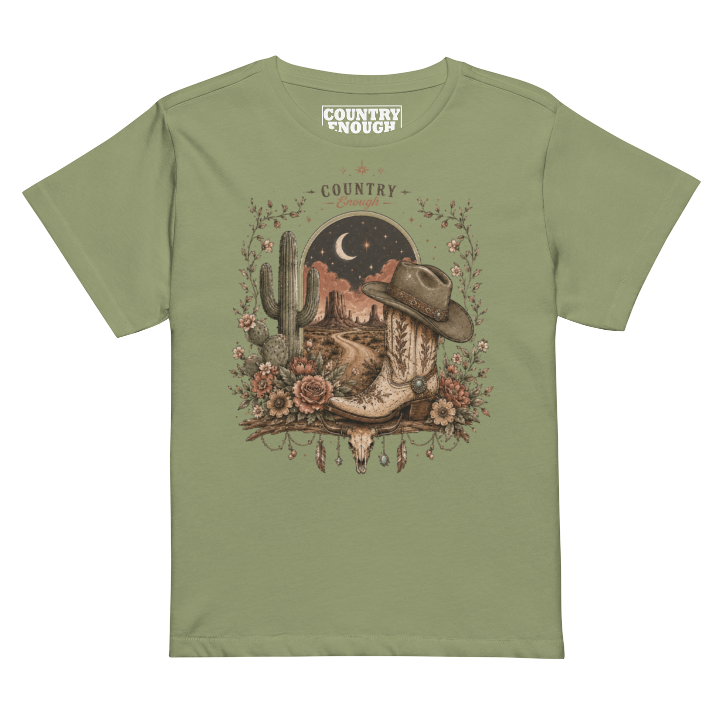 Women's t-shirt with graphic of bull skull, cowboy boot, cowboy hat, desert landscape and night sky. #artichoke