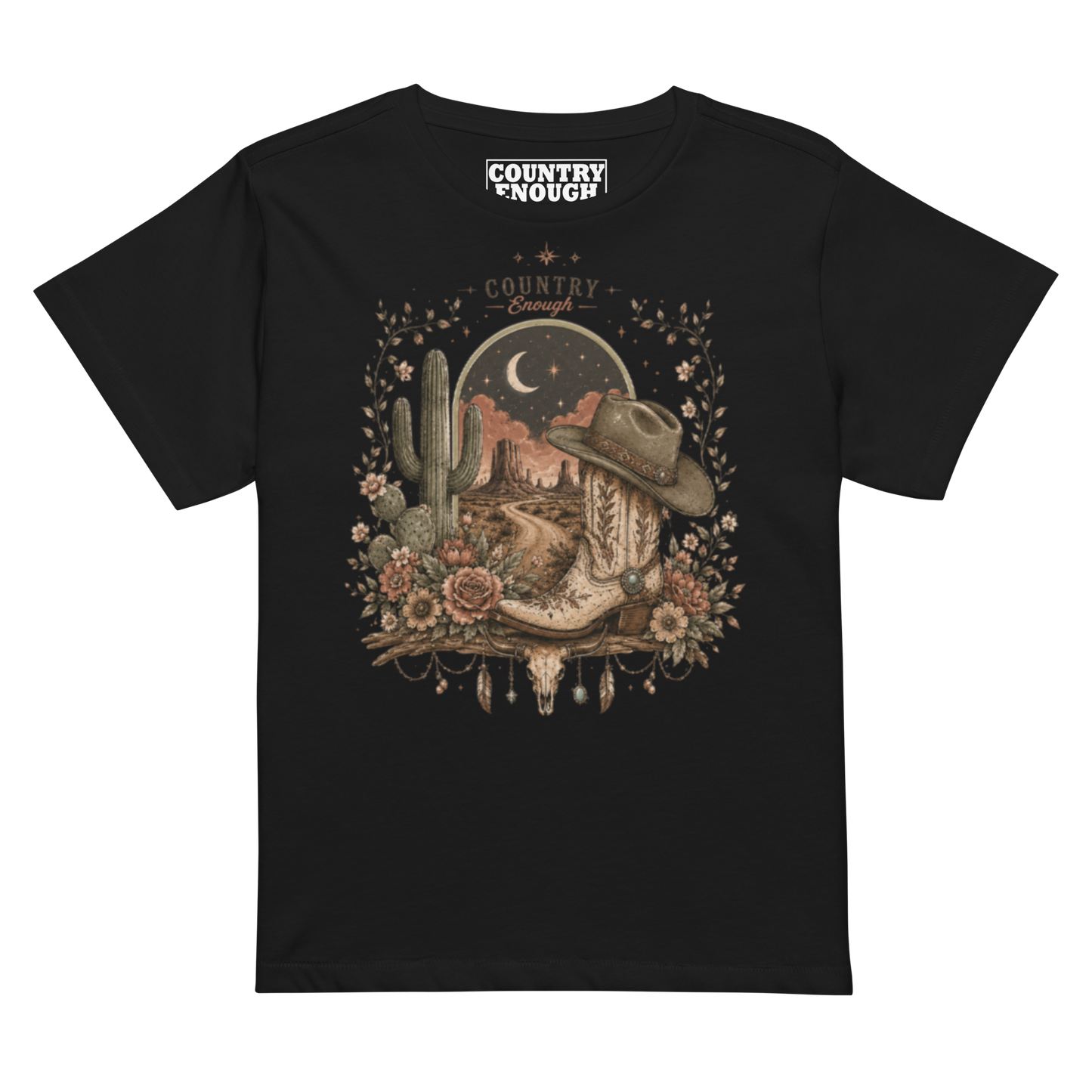 Women's t-shirt with graphic of bull skull, cowboy boot, cowboy hat, desert landscape and night sky. #black