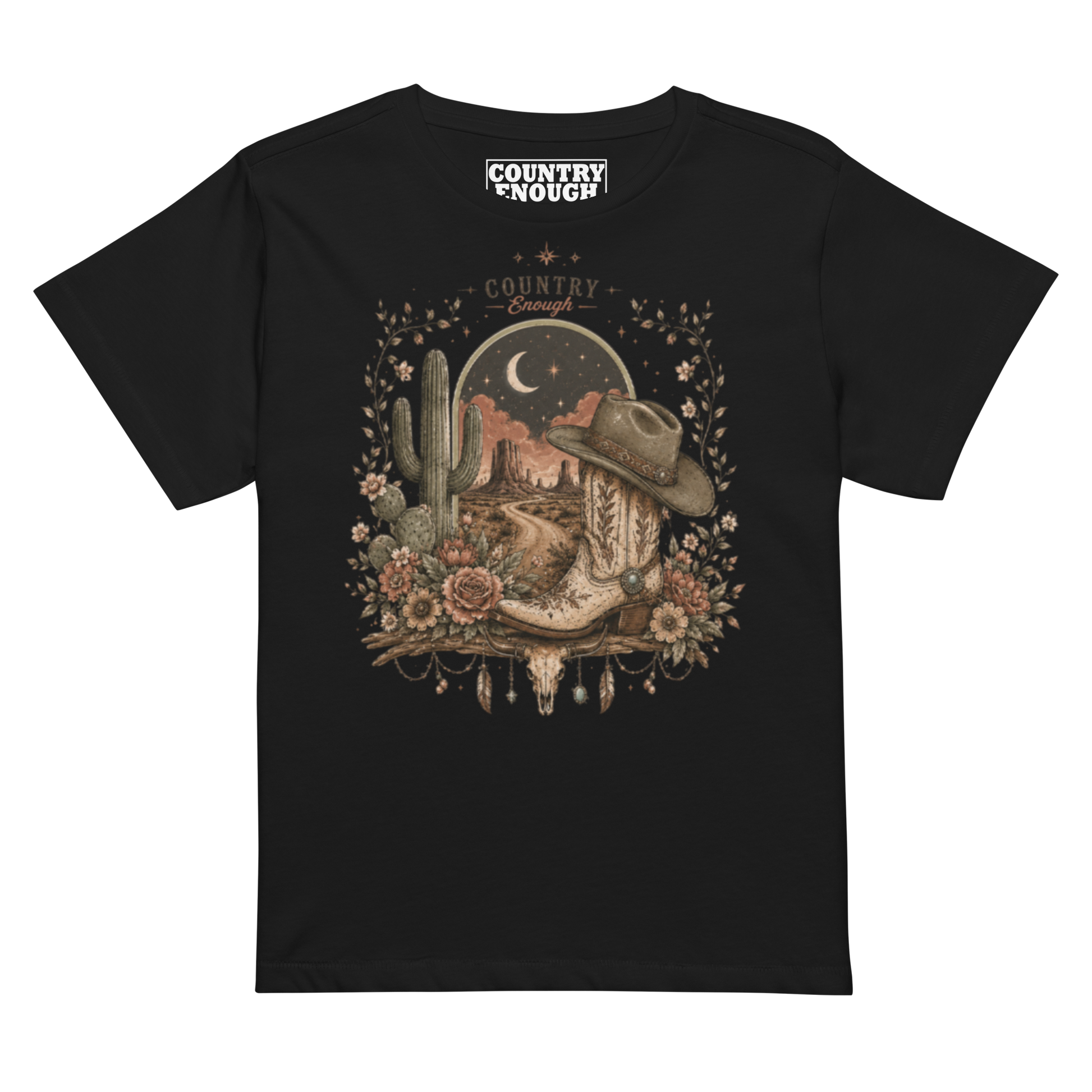 Women's t-shirt with graphic of bull skull, cowboy boot, cowboy hat, desert landscape and night sky. #black