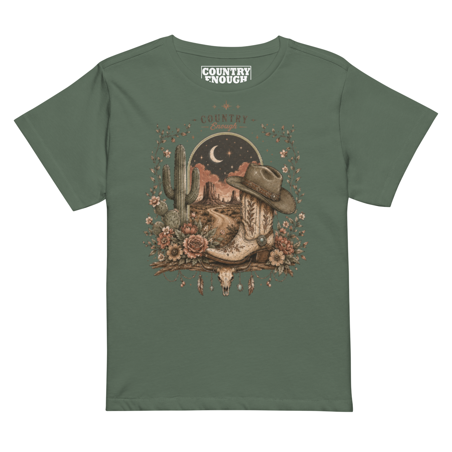 Women's t-shirt with graphic of bull skull, cowboy boot, cowboy hat, desert landscape and night sky. #pine