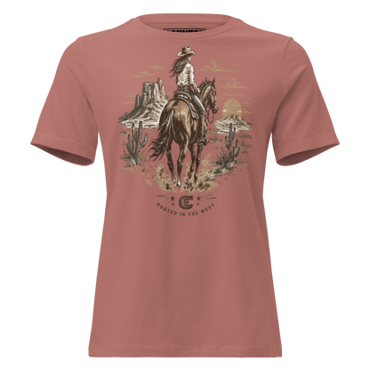 cowgirl head west on a horse in the desert landscape with the sun setting in the distance with ce logo and words rooted in the west #mauve