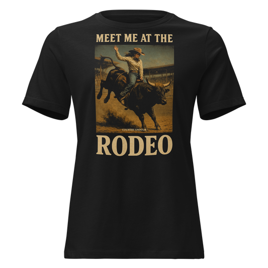 Black t-shirt with graphic of cowgirl riding a bucking bull and the words meet me at the rodeo #black